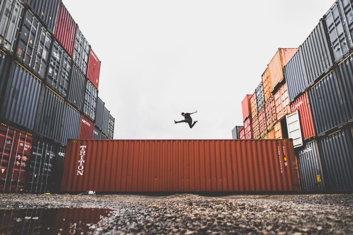 Image of a man jumping on shipping containers